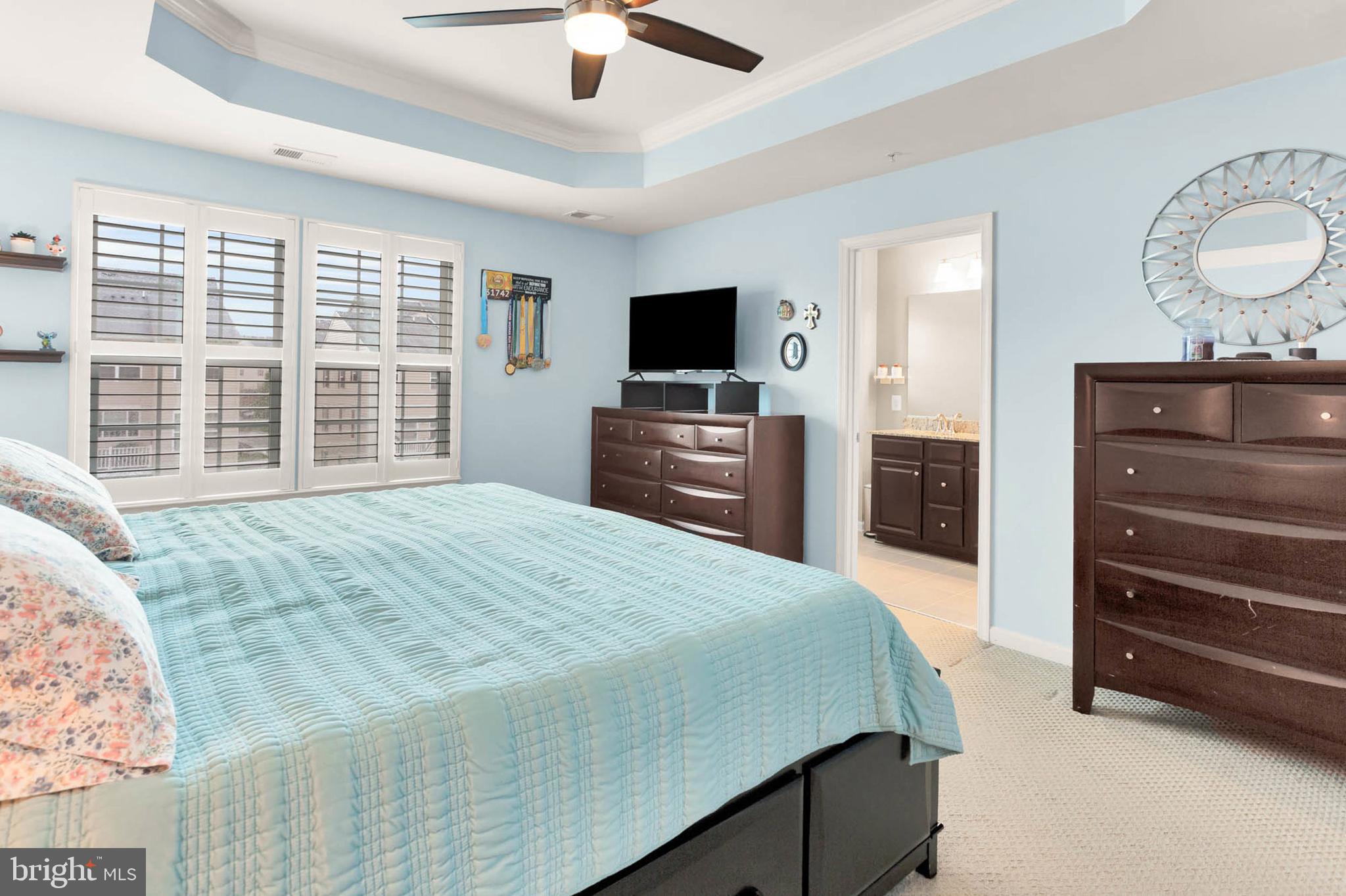 6367 Walcott Lane Frederick, MD 21703 - Photo 18 of 43 a bedroom with a bed and a flat screen tv