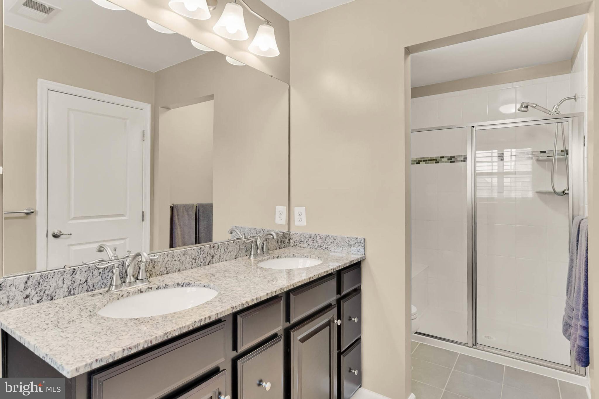 6367 Walcott Lane Frederick, MD 21703 - Photo 20 of 43 a bathroom with a granite countertop sink and a mirror