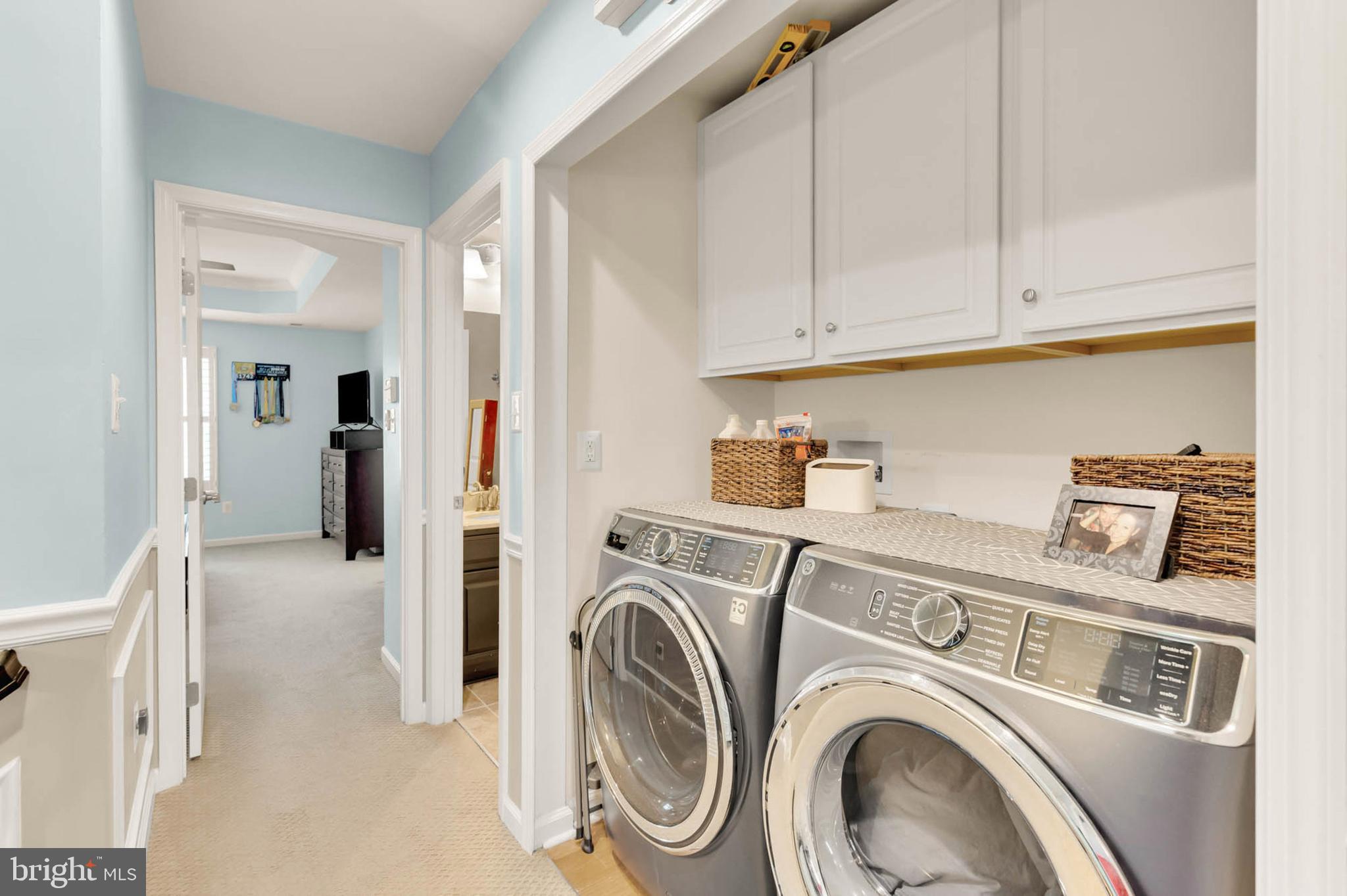 6367 Walcott Lane Frederick, MD 21703 - Photo 21 of 43 a view of washer and dryer with kitchen in the background