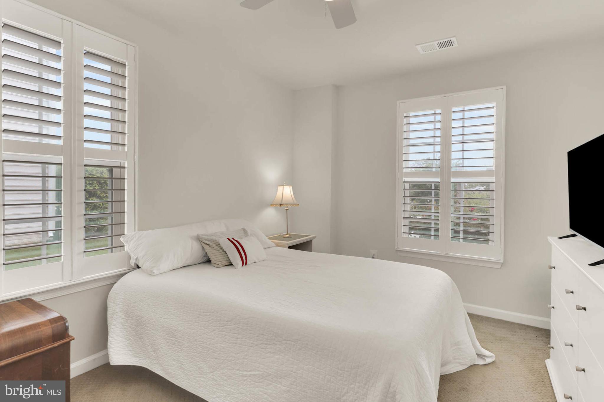 6367 Walcott Lane Frederick, MD 21703 - Photo 27 of 43 a bedroom with a bed and a flat tv screen next to a window