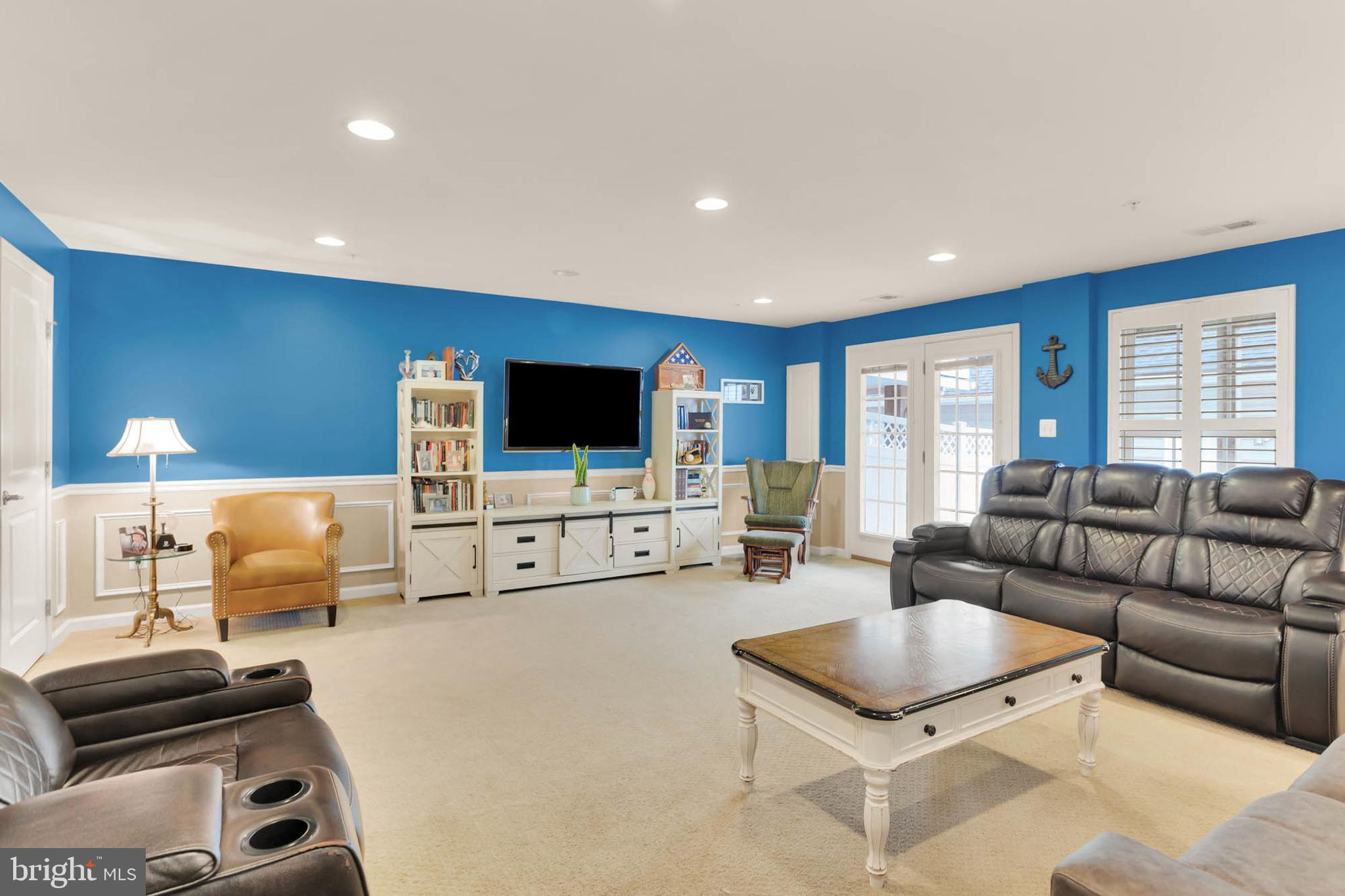 6367 Walcott Lane Frederick, MD 21703 - Photo 32 of 43 a living room with furniture and a flat screen tv