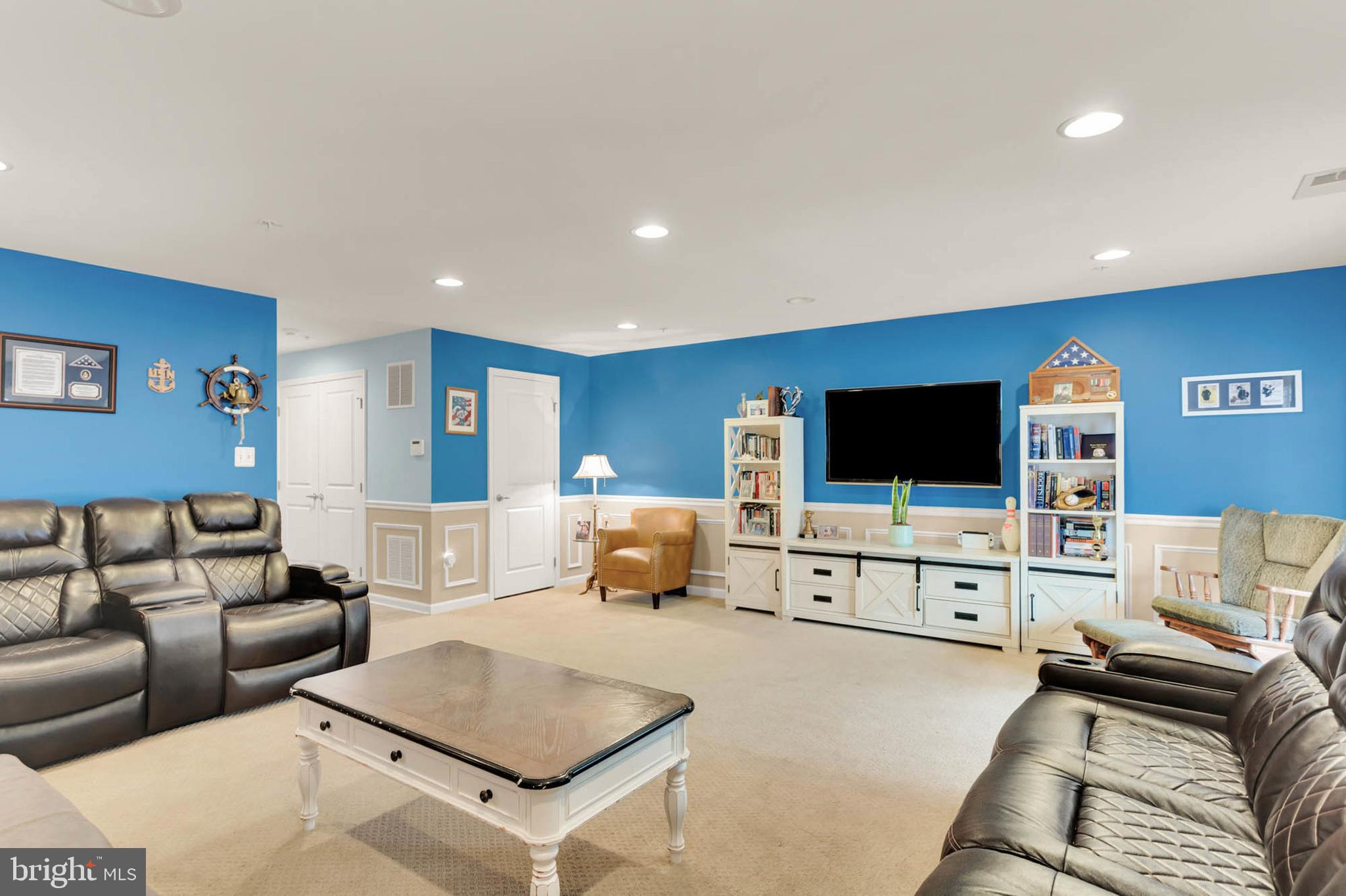 6367 Walcott Lane Frederick, MD 21703 - Photo 33 of 43 a living room with furniture and a flat screen tv