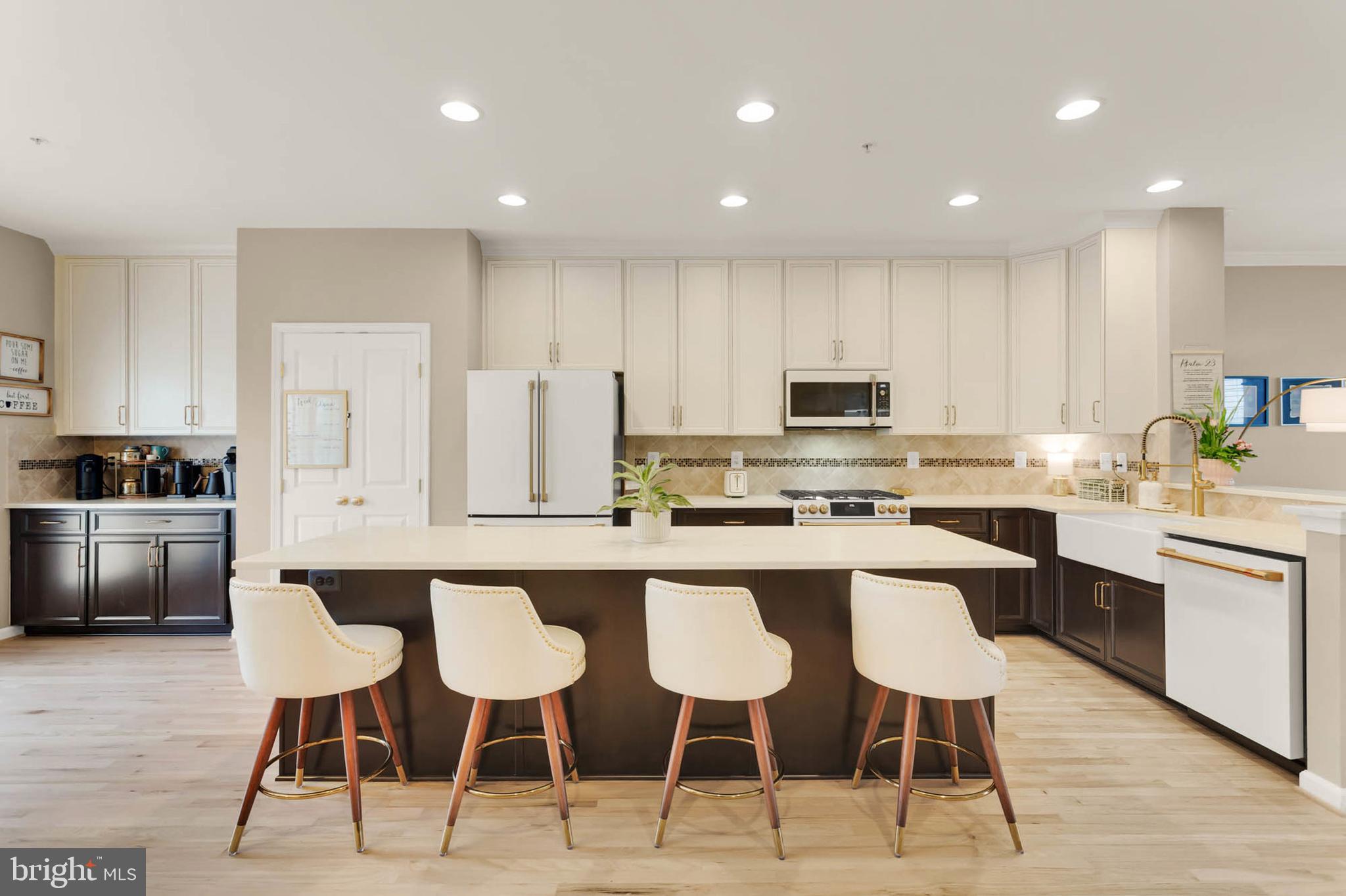 6367 Walcott Lane Frederick, MD 21703 - Photo 8 of 43 a kitchen with stainless steel appliances kitchen island granite countertop a table and chairs