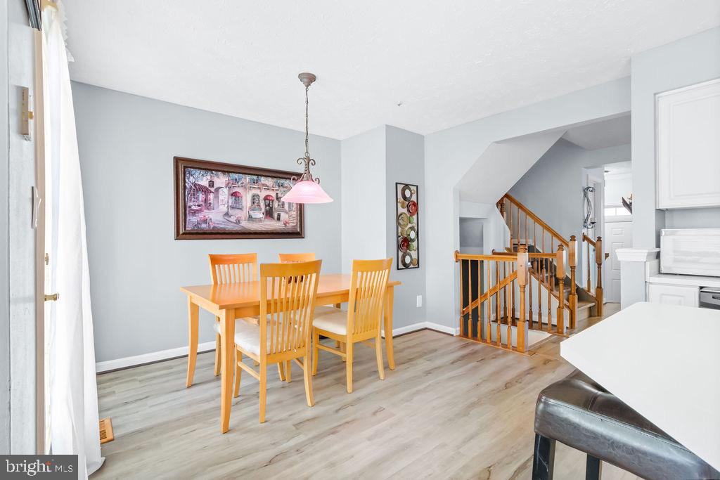 8605 Accokeek Street Laurel, MD 20724 - Photo 12 of 44 a view of a dining room with furniture and wooden floor