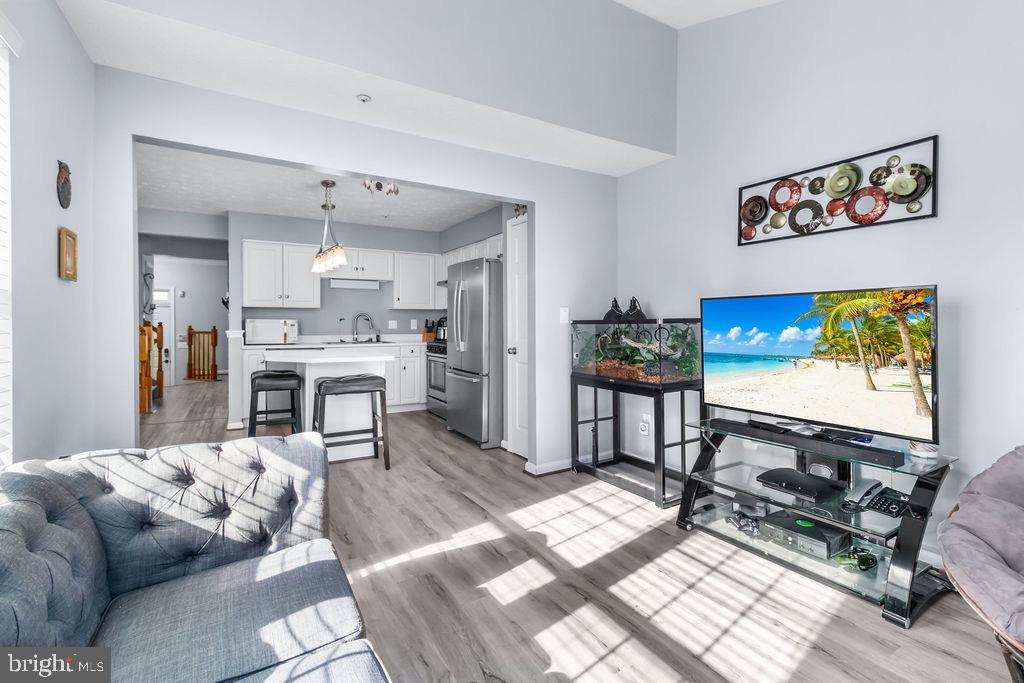 8605 Accokeek Street Laurel, MD 20724 - Photo 20 of 44 a living room with furniture a flat screen tv and a table
