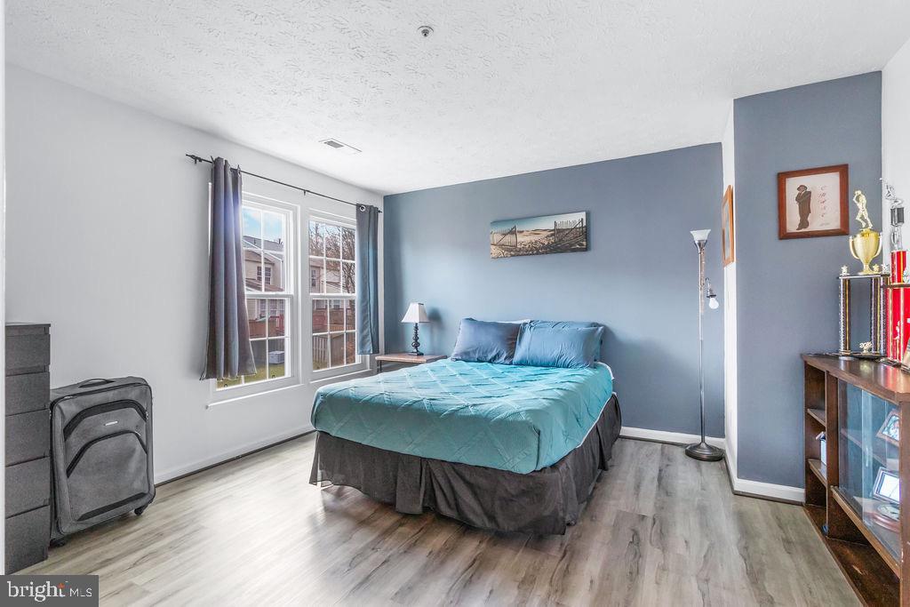 8605 Accokeek Street Laurel, MD 20724 - Photo 26 of 44 a bedroom with a bed and a flat screen tv on the dresser