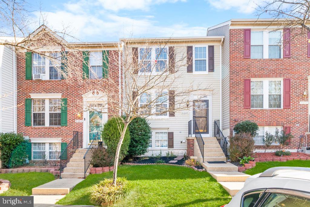 8605 Accokeek Street Laurel, MD 20724 - Photo 4 of 44 a front view of a building with garden and trees