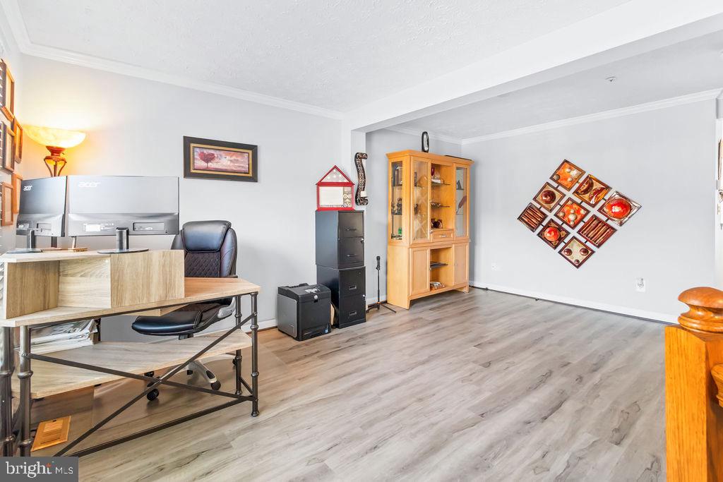 8605 Accokeek Street Laurel, MD 20724 - Photo 8 of 44 a workspace with furniture and wooden floor