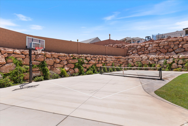 1192 East Corral Way Washington, UT 84780 - Photo 66 of 81 Concrete sport court featuring a basketball hoop and net