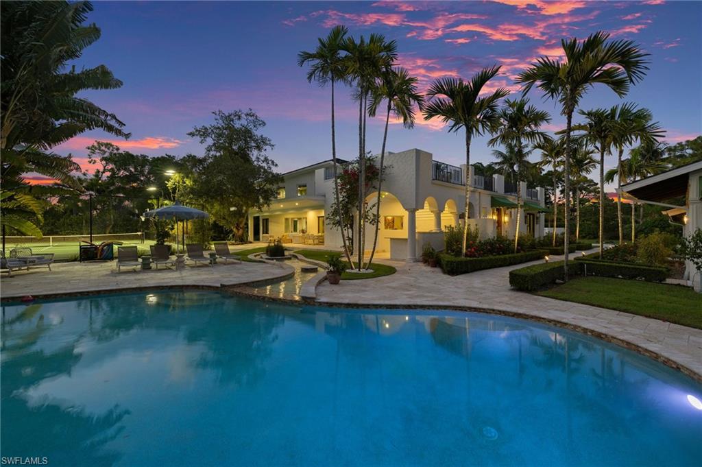 111 Caribbean Road Naples, FL 34108 - Photo 45 of 50 a view of outdoor space with swimming pool and lake view