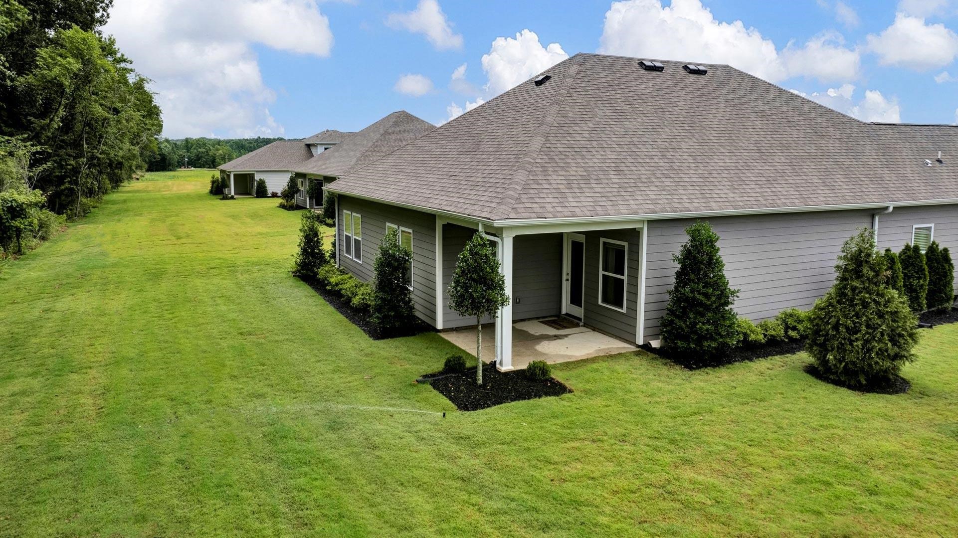 345 Windemere Loop Oakland, TN 38060 - Photo 22 of 23 a view of a house with backyard porch and garden