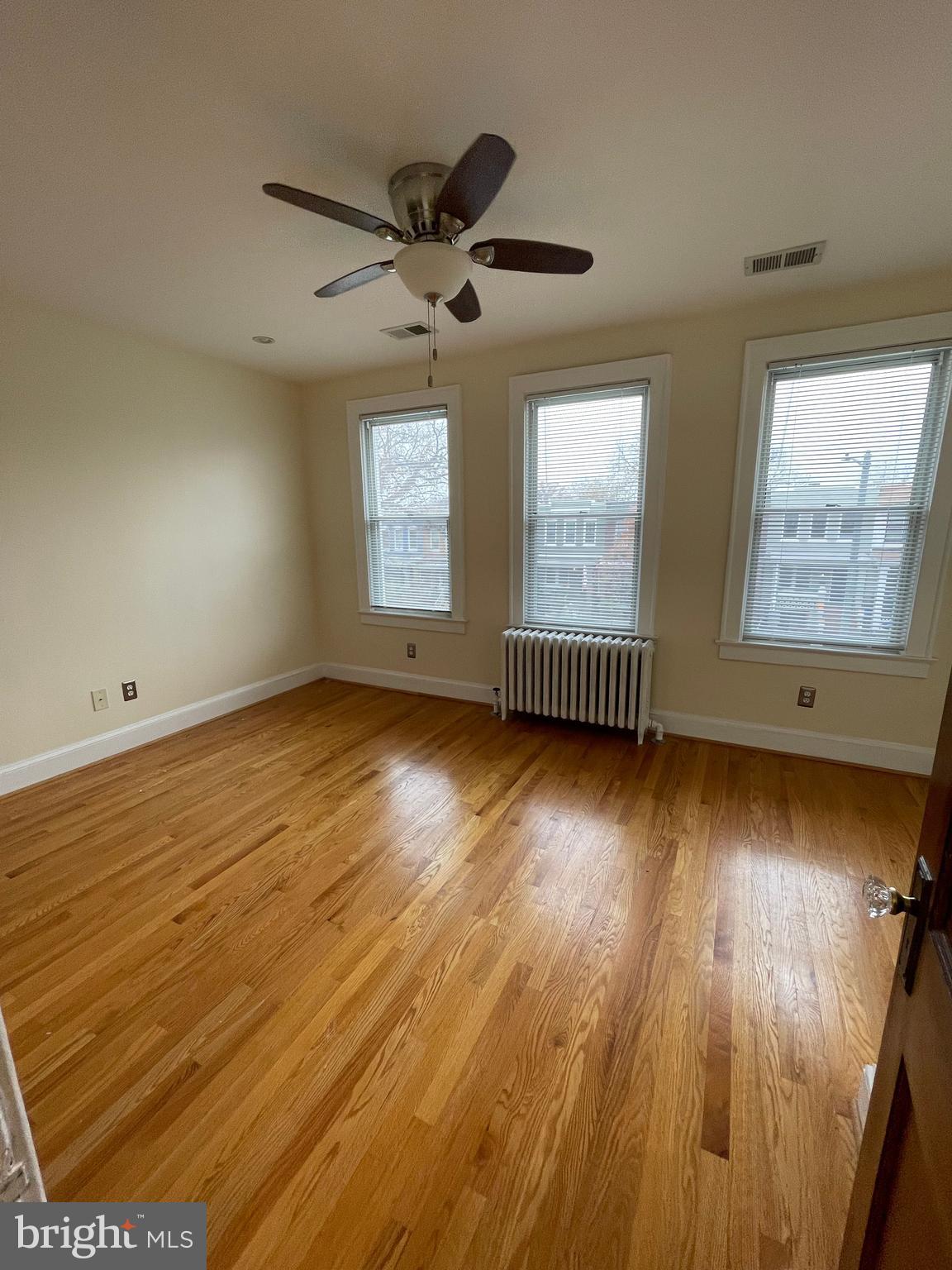 539 24th Street Northeast Washington, DC 20002 - Photo 15 of 37 an empty room with wooden floor and windows