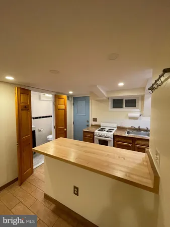 a kitchen with stainless steel appliances a refrigerator and a stove top oven
