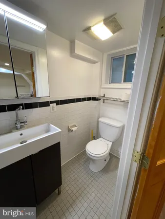 a bathroom with a sink a toilet a mirror and vanity