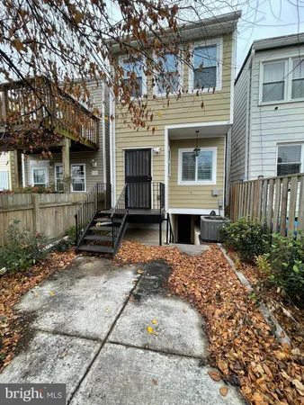 a view of a house with a yard and sitting area