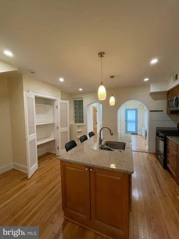 a kitchen with sink refrigerator and microwave