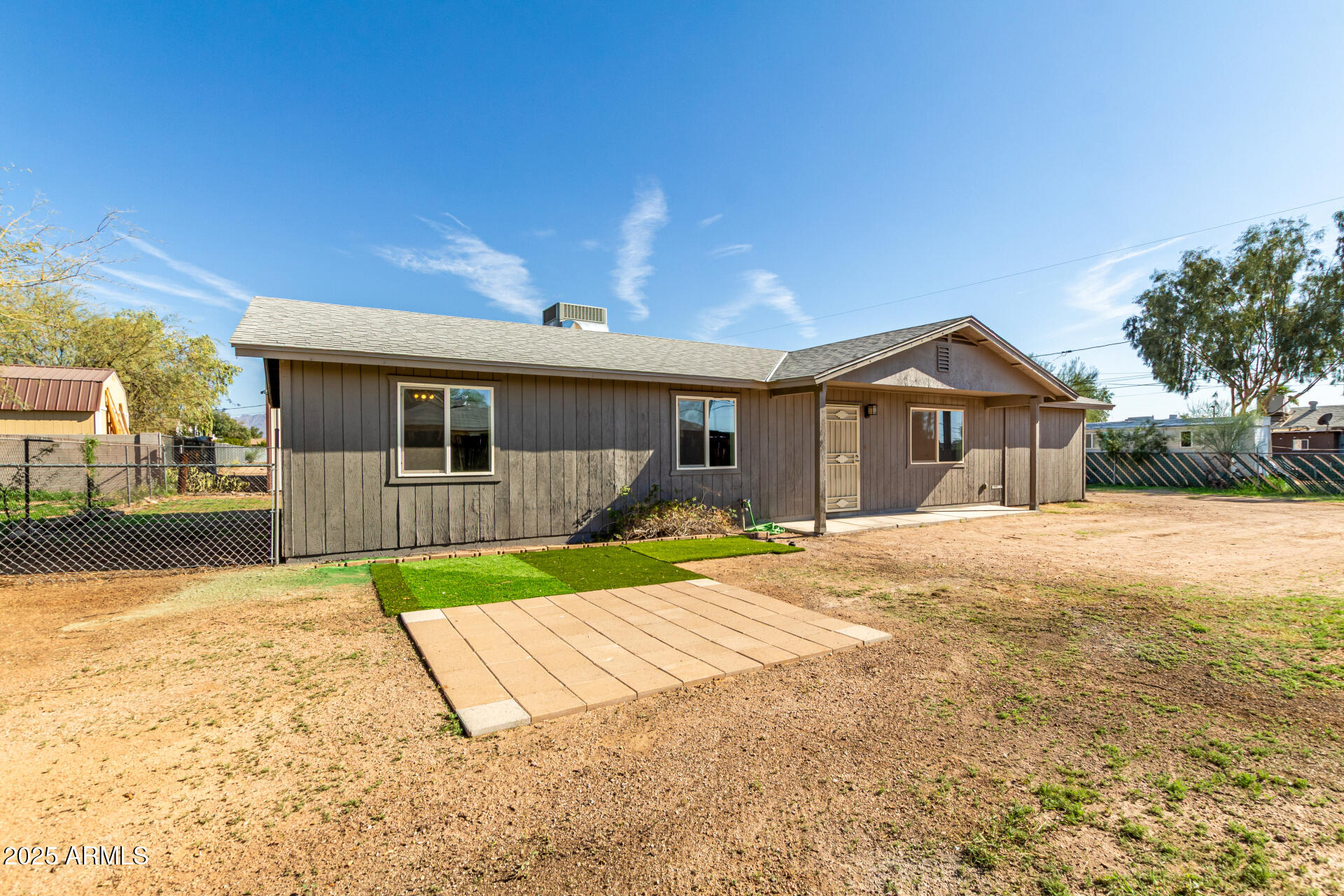 301 South Elmont Drive Apache Junction, AZ 85120 - Photo 2 of 32 a view of a house with a yard and potted plants