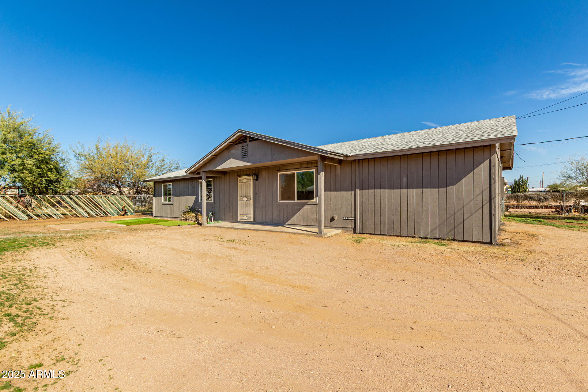 301 South Elmont Drive Apache Junction, AZ 85120 - Photo 30 of 32 a wooden house with a outdoor space
