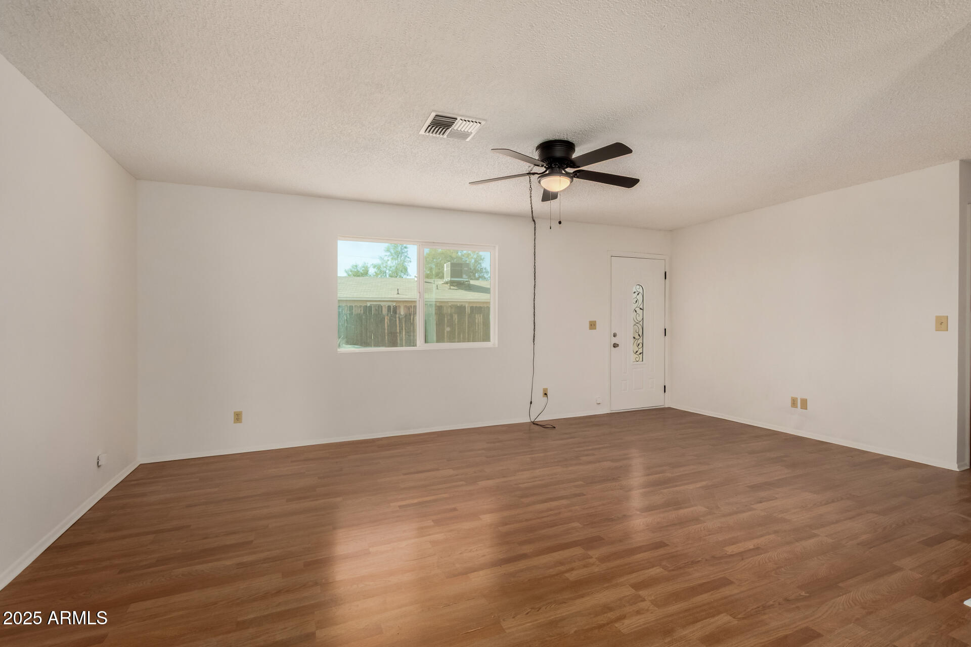 301 South Elmont Drive Apache Junction, AZ 85120 - Photo 6 of 32 wooden floor in an empty room with a window