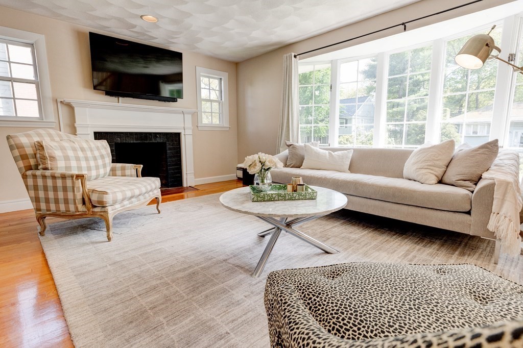 23 Bonwood Road Needham, MA 02492 - Photo 5 of 28 a living room with furniture a flat screen tv and a fireplace