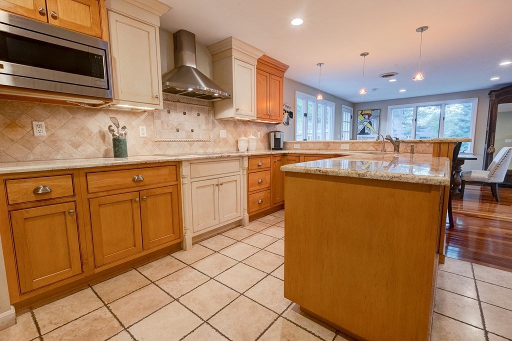 23 Bonwood Road Needham, MA 02492 - Photo 9 of 28 a kitchen with stainless steel appliances granite countertop a sink and a stove