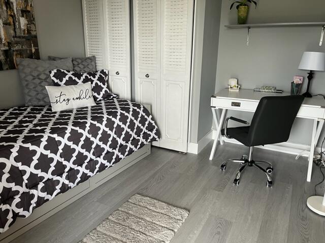 6461 Northwest 2nd Avenue, Unit 409 Boca Raton, FL 33487 - Photo 13 of 61 a bedroom with a bed and a chair