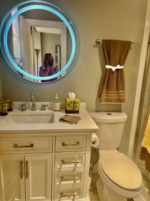 6461 Northwest 2nd Avenue, Unit 409 Boca Raton, FL 33487 - Photo 16 of 61 a bathroom with a toilet sink and mirror