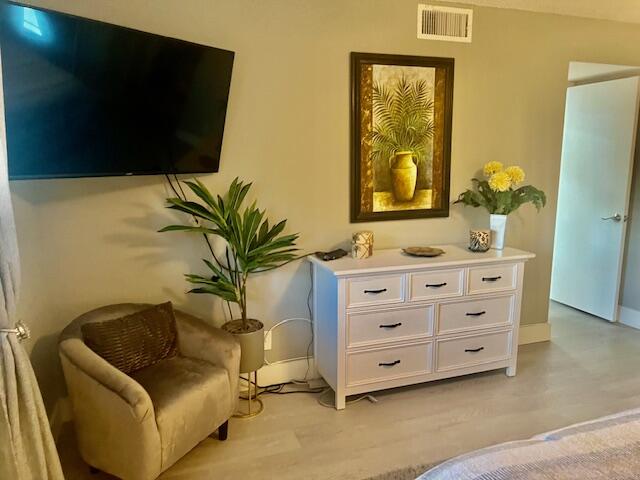 6461 Northwest 2nd Avenue, Unit 409 Boca Raton, FL 33487 - Photo 21 of 61 a bathroom with a granite countertop sink a mirror and a potted plant