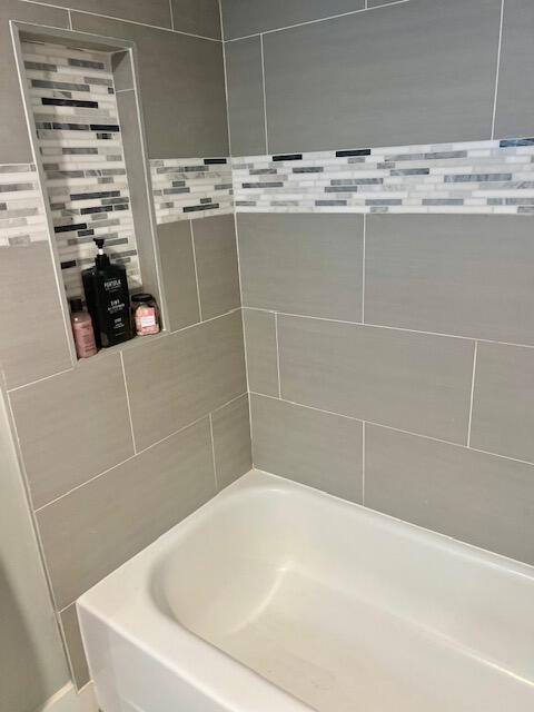 6461 Northwest 2nd Avenue, Unit 409 Boca Raton, FL 33487 - Photo 24 of 61 a bathroom with a white bath tub