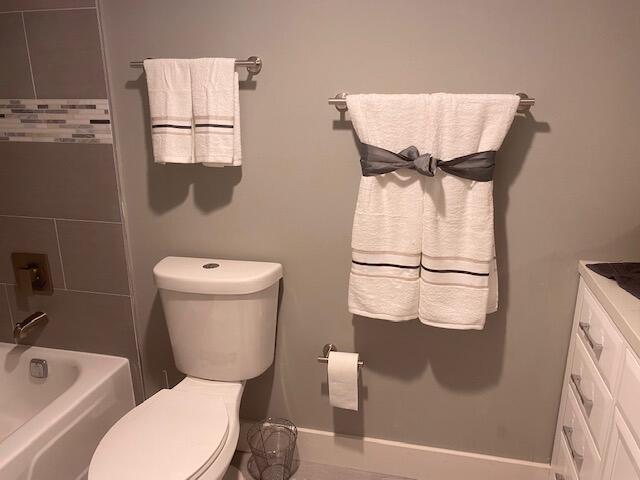 6461 Northwest 2nd Avenue, Unit 409 Boca Raton, FL 33487 - Photo 27 of 61 a bathroom with a toilet sink and mirror