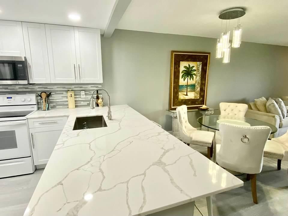 6461 Northwest 2nd Avenue, Unit 409 Boca Raton, FL 33487 - Photo 3 of 61 a bed room with a bed and a chair