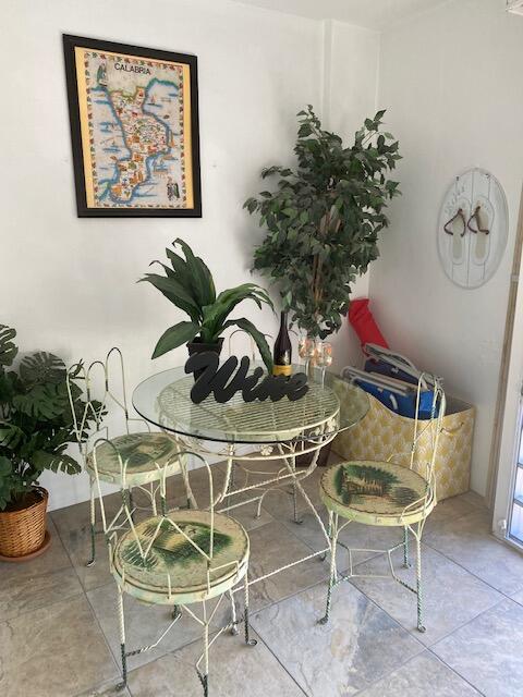 6461 Northwest 2nd Avenue, Unit 409 Boca Raton, FL 33487 - Photo 35 of 61 a view of a dining room with furniture and a potted plant