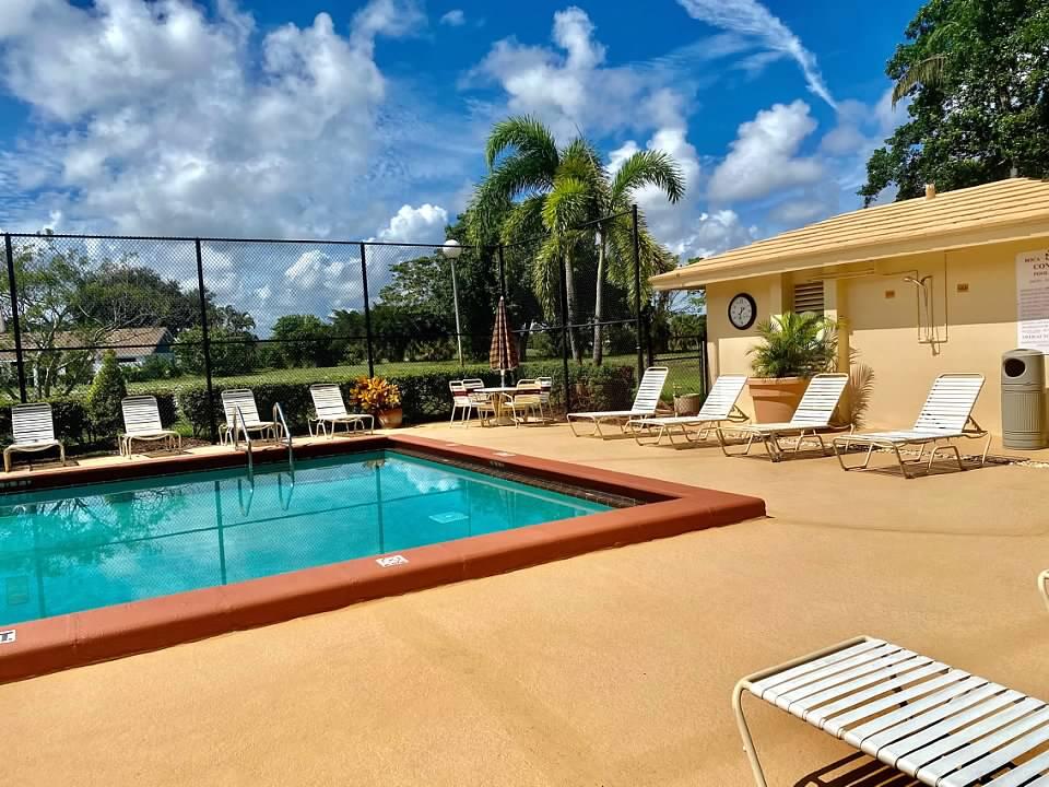 6461 Northwest 2nd Avenue, Unit 409 Boca Raton, FL 33487 - Photo 40 of 61 a view of a patio with swimming pool