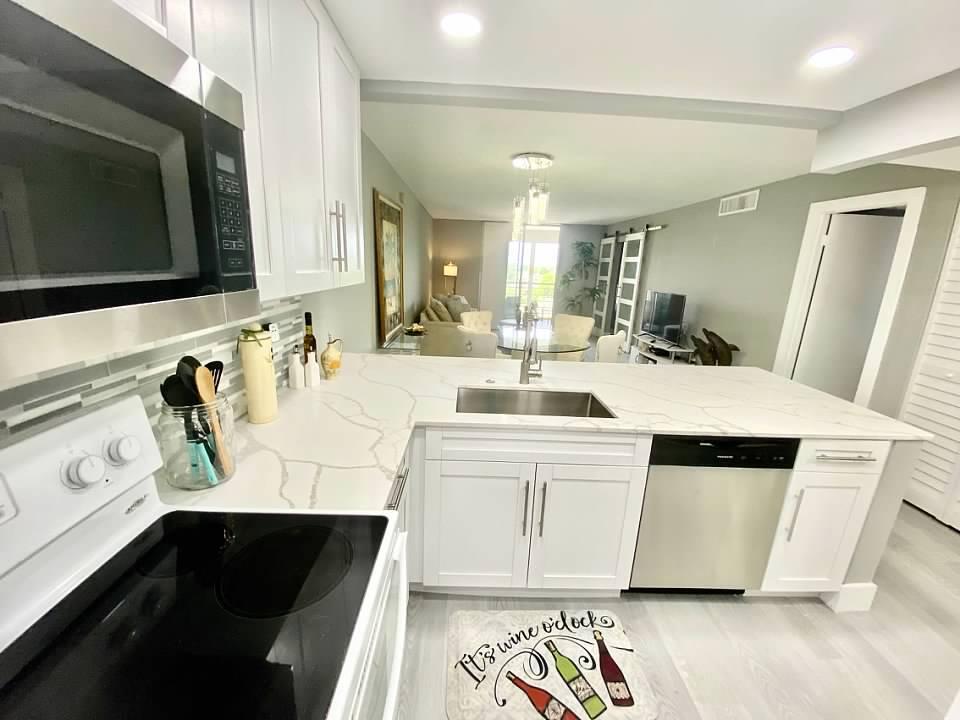 6461 Northwest 2nd Avenue, Unit 409 Boca Raton, FL 33487 - Photo 4 of 61 a bathroom with a sink double vanity and mirror