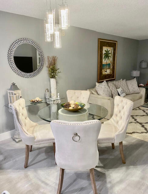 6461 Northwest 2nd Avenue, Unit 409 Boca Raton, FL 33487 - Photo 7 of 61 a living room with furniture and a chandelier