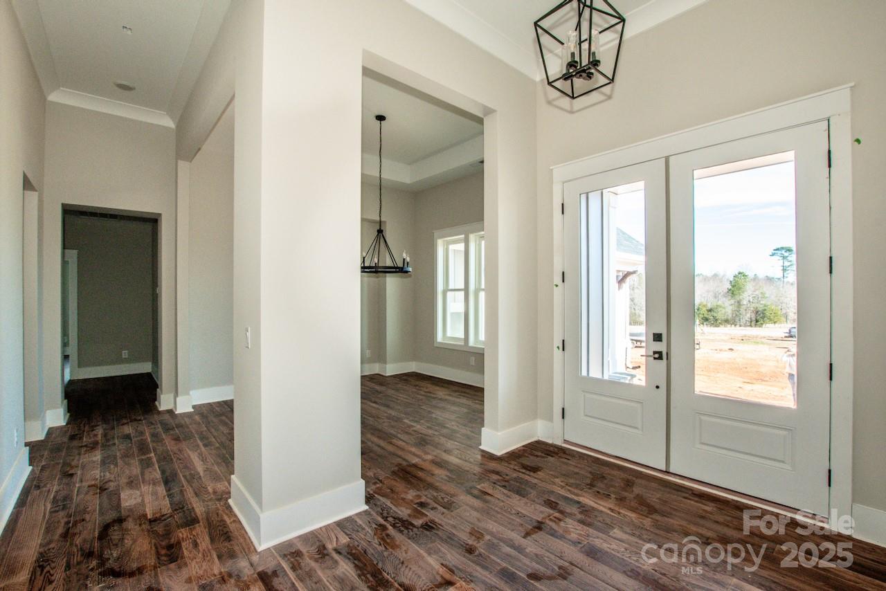 6098 Ballard Road Denver, NC 28037 - Photo 13 of 48 a view of a hallway with wooden floor and a chandelier