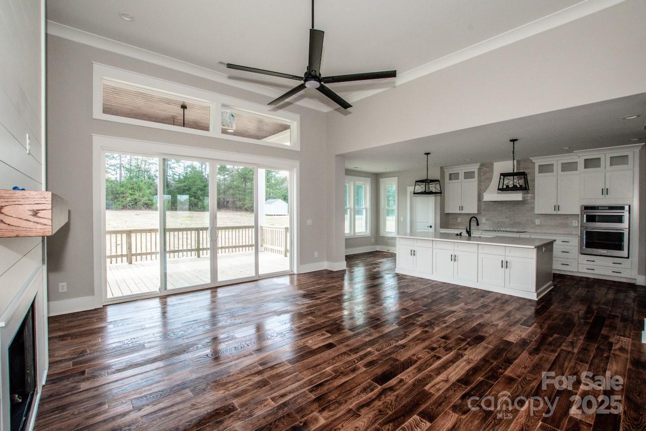 6098 Ballard Road Denver, NC 28037 - Photo 15 of 48 a large kitchen with cabinets wooden floor and a fireplace