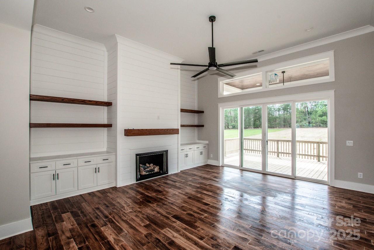 6098 Ballard Road Denver, NC 28037 - Photo 16 of 48 a view of empty room with fireplace and wooden floor