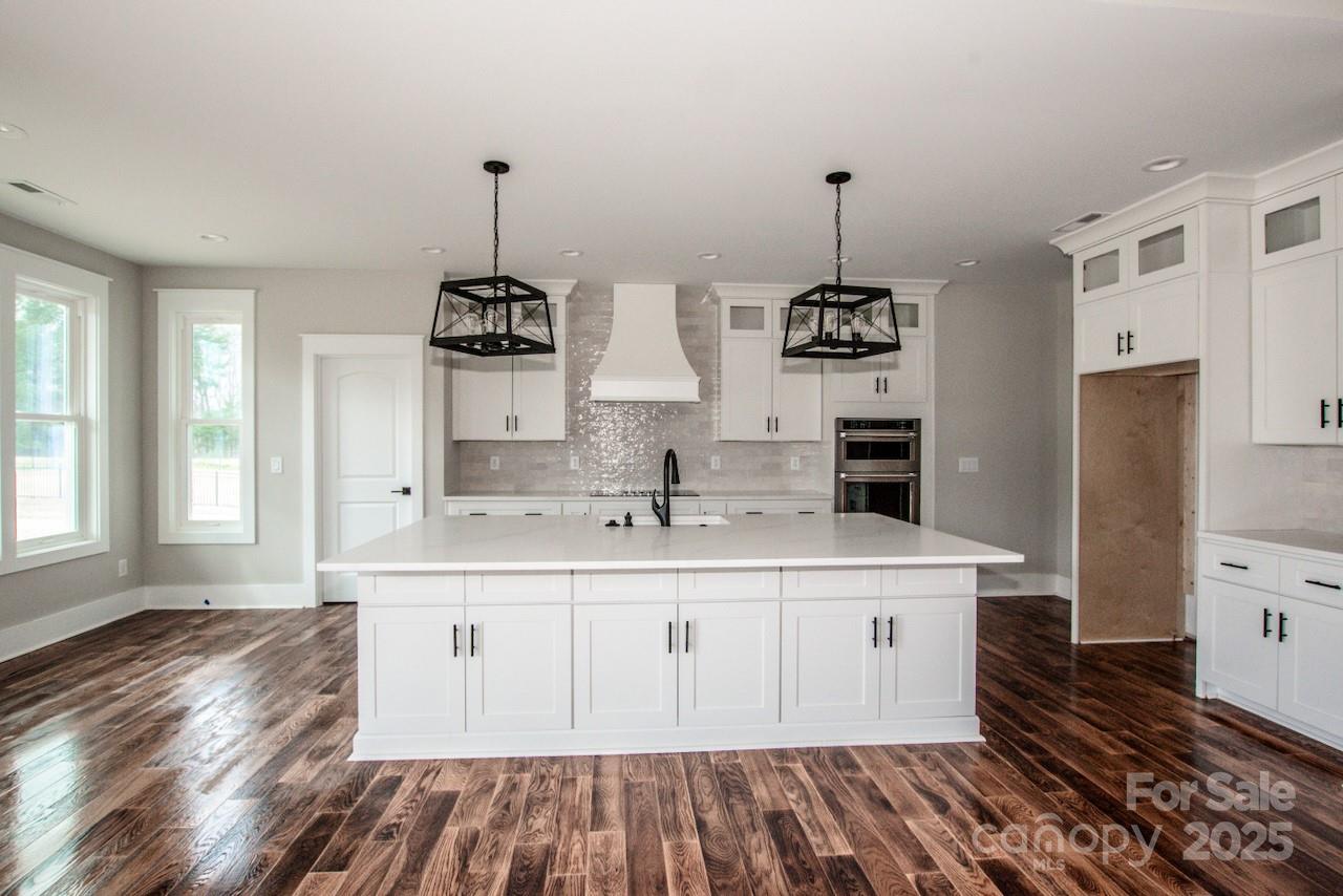 6098 Ballard Road Denver, NC 28037 - Photo 18 of 48 a kitchen with a sink stove and cabinets