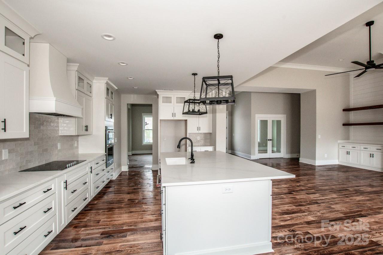 6098 Ballard Road Denver, NC 28037 - Photo 20 of 48 a kitchen with kitchen island granite countertop a sink a counter space and stainless steel appliances