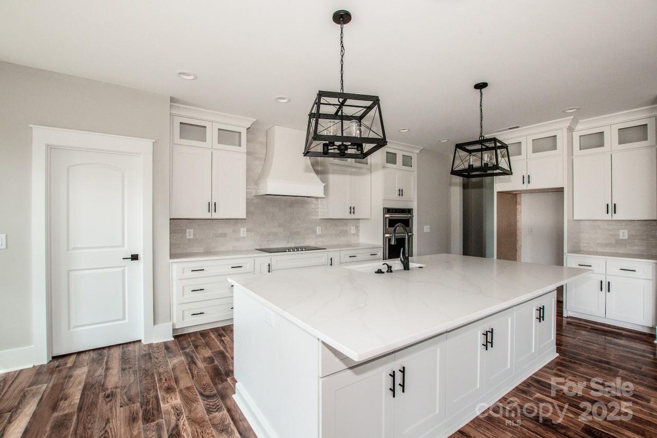 6098 Ballard Road Denver, NC 28037 - Photo 21 of 48 a kitchen with stainless steel appliances granite countertop a sink stove and refrigerator