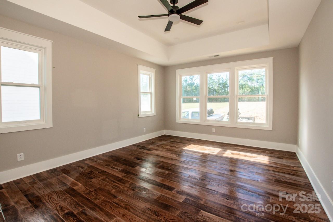 6098 Ballard Road Denver, NC 28037 - Photo 31 of 48 a view of an empty room with wooden floor and a window