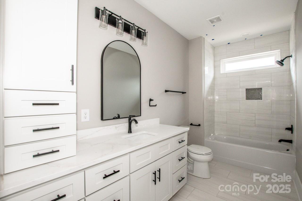 6098 Ballard Road Denver, NC 28037 - Photo 37 of 48 a bathroom with a sink a toilet and shower