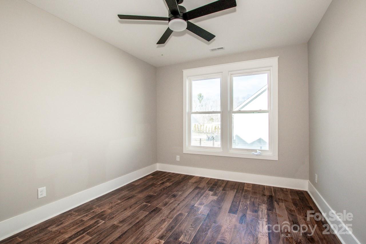 6098 Ballard Road Denver, NC 28037 - Photo 38 of 48 a view of empty room with wooden floor and fan