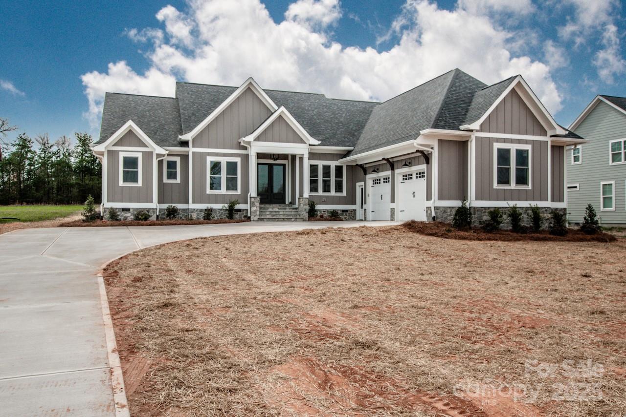 6098 Ballard Road Denver, NC 28037 - Photo 4 of 48 a front view of a house with a yard
