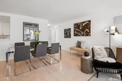 a kitchen with stainless steel appliances white cabinets and a stove a refrigerator a sink
