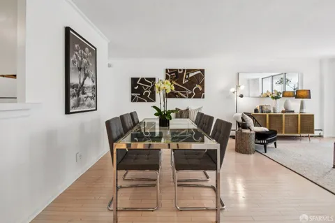 a kitchen with stainless steel appliances a sink dishwasher stove and white cabinets
