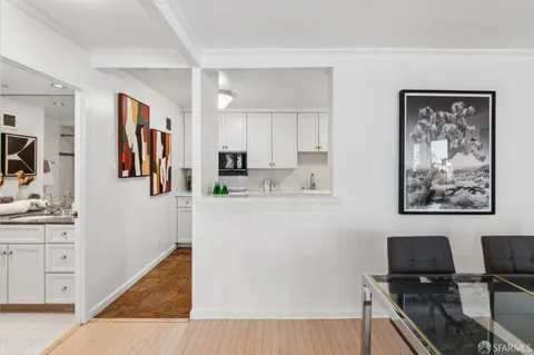 a kitchen with stainless steel appliances granite countertop a sink a stove and a wooden floor