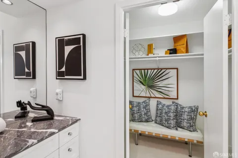 a bedroom with a bed and a painting on the wall