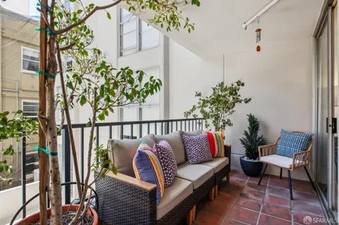 a living room with furniture a ceiling fan and a rug
